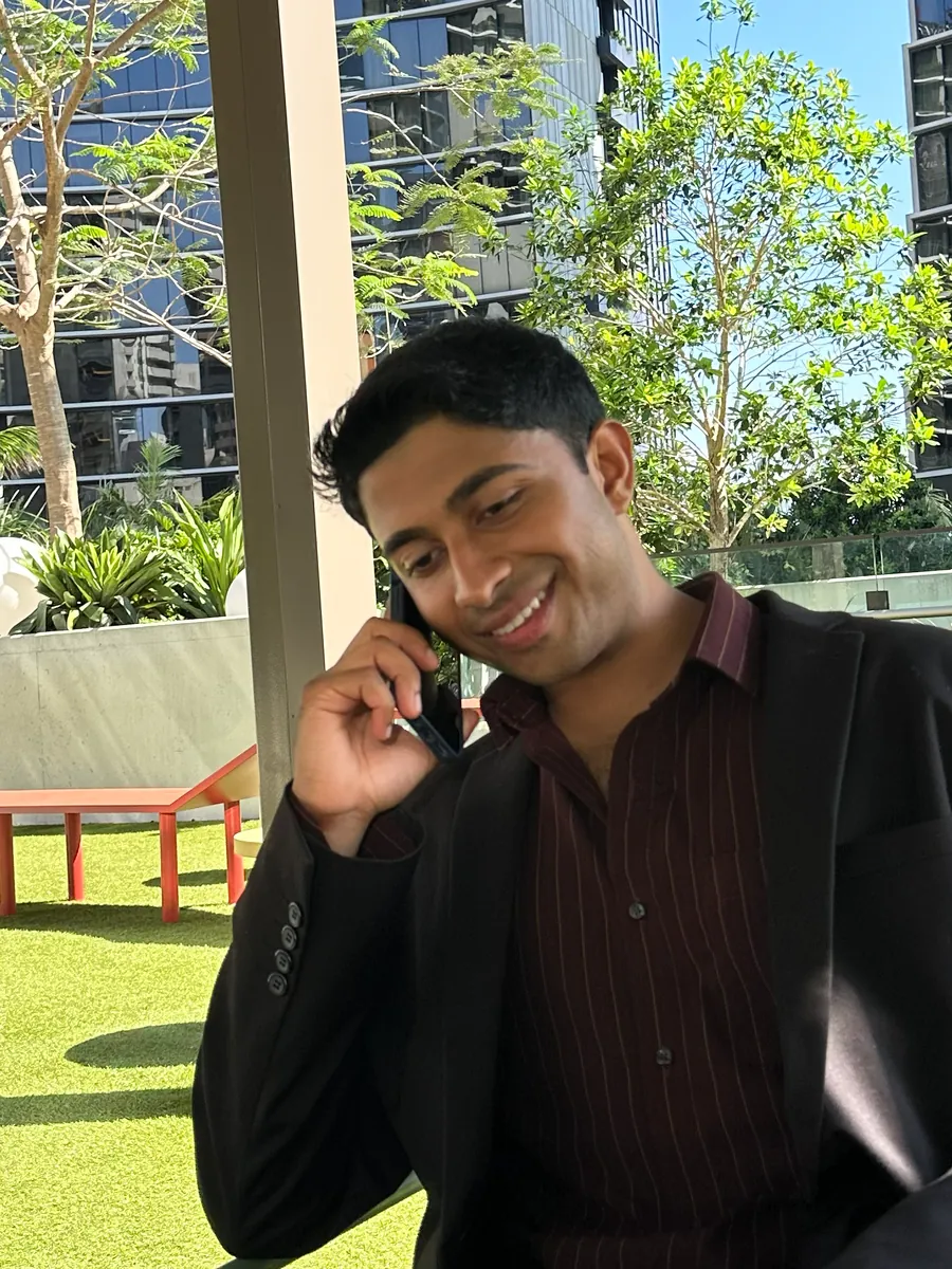 Premal Patel, on a phone call outdoors with city buildings behind him