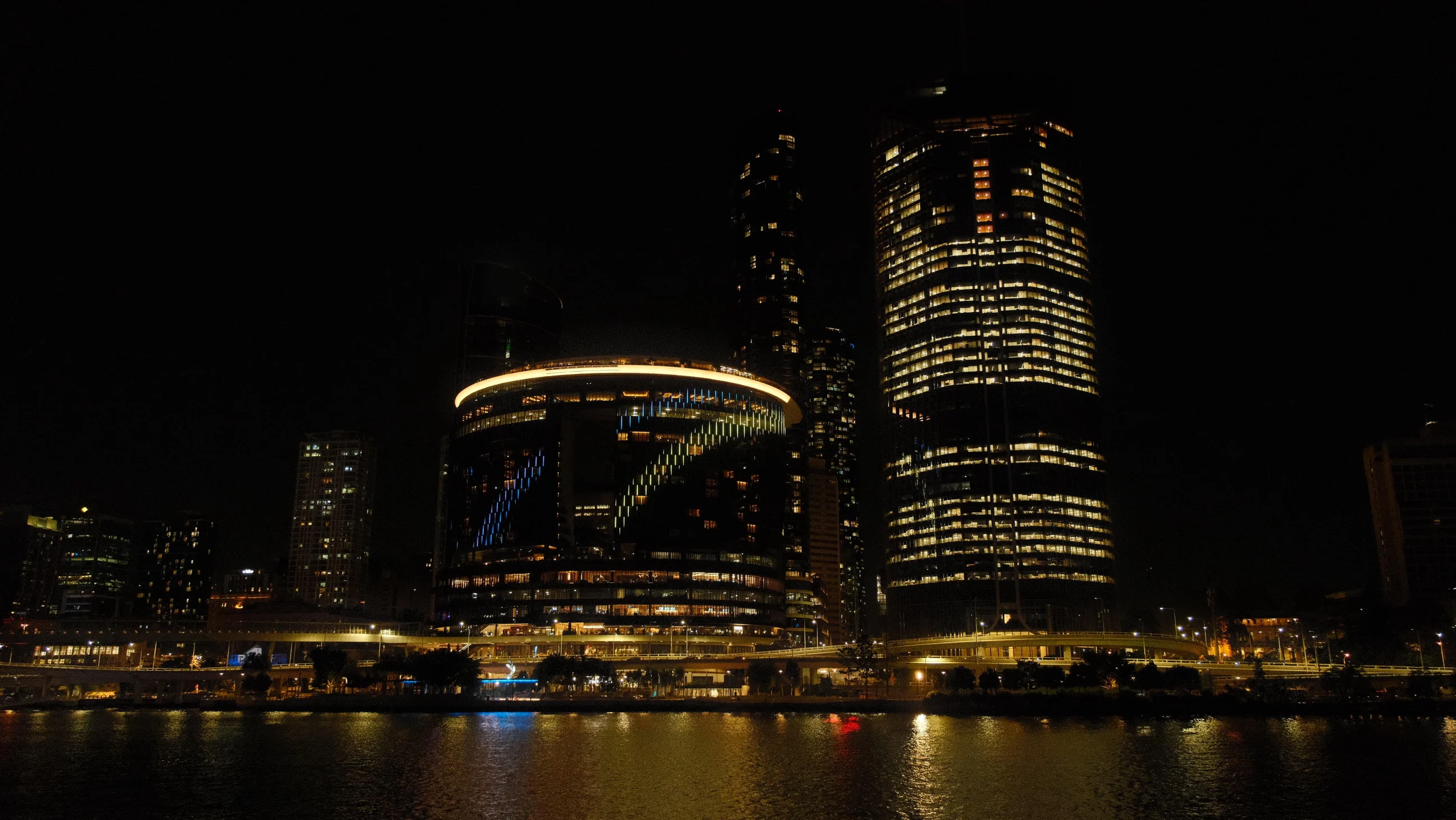 A city skyline at dusk through floor-to-ceiling glass