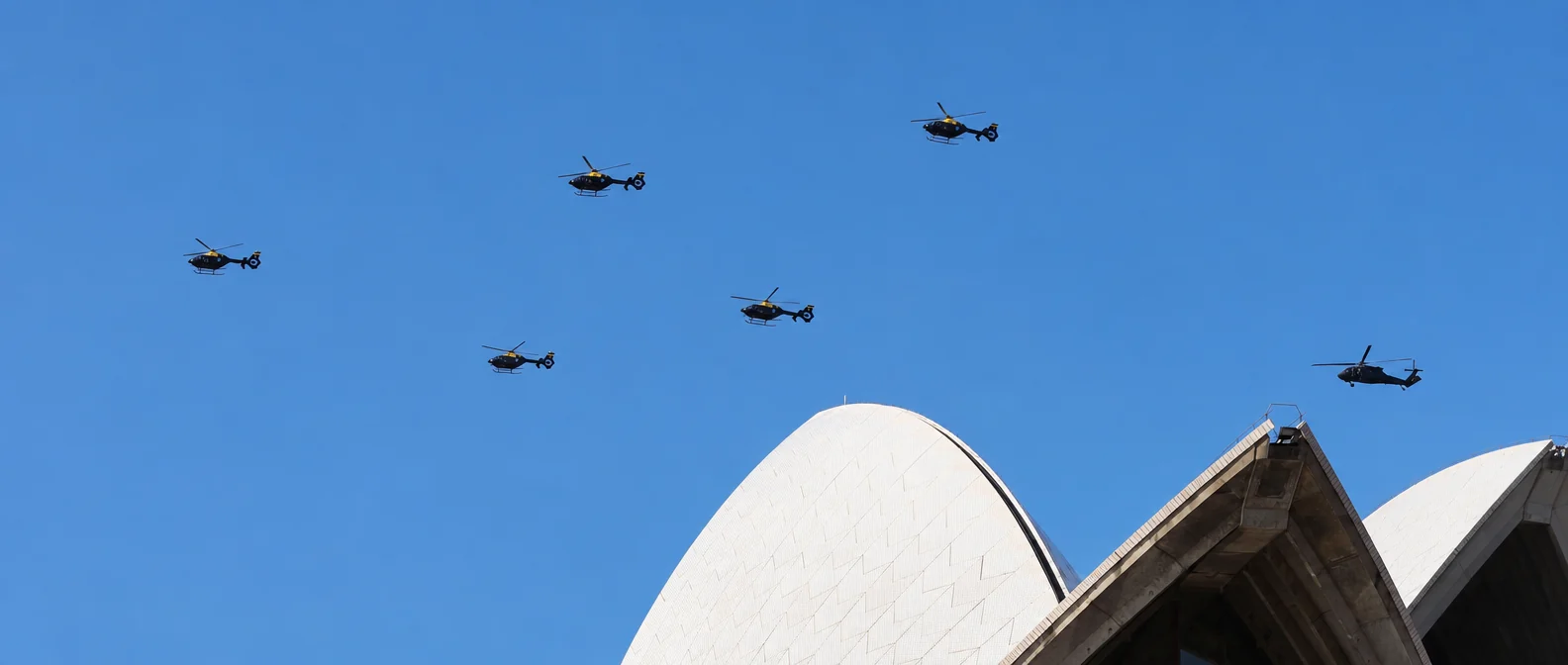 Helicopters flying in formation over the sails of the Sydney Opera House
